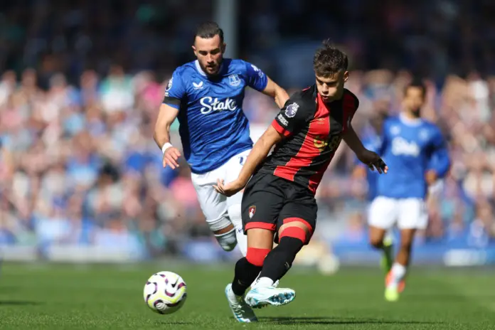 LIVERPOOL, ENGLAND - AUGUST 31: Milos Kerkez of AFC Bournemouth passes the ball under pressure from Jack Harrison of Everton during the Premier League match between Everton FC and AFC Bournemouth at Goodison Park on August 31, 2024 in Liverpool, England.